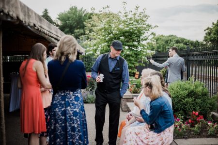 Wedding guests enjoy the outdoor courtyard surrounded by gardens at Beaver Station