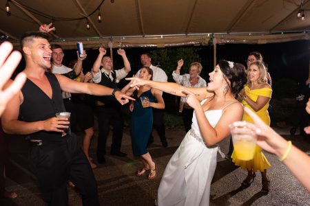 Bride and groom dance the night away on the covered Trackside Courtyard