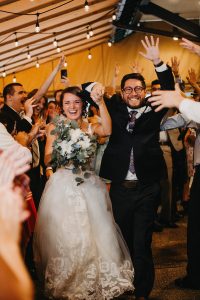 A happy couple enters the Trackside Courtyard surrounded by gardens at Beaver Station