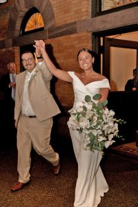 A happy couple steps on the outdoor dance floor from the historic dining room